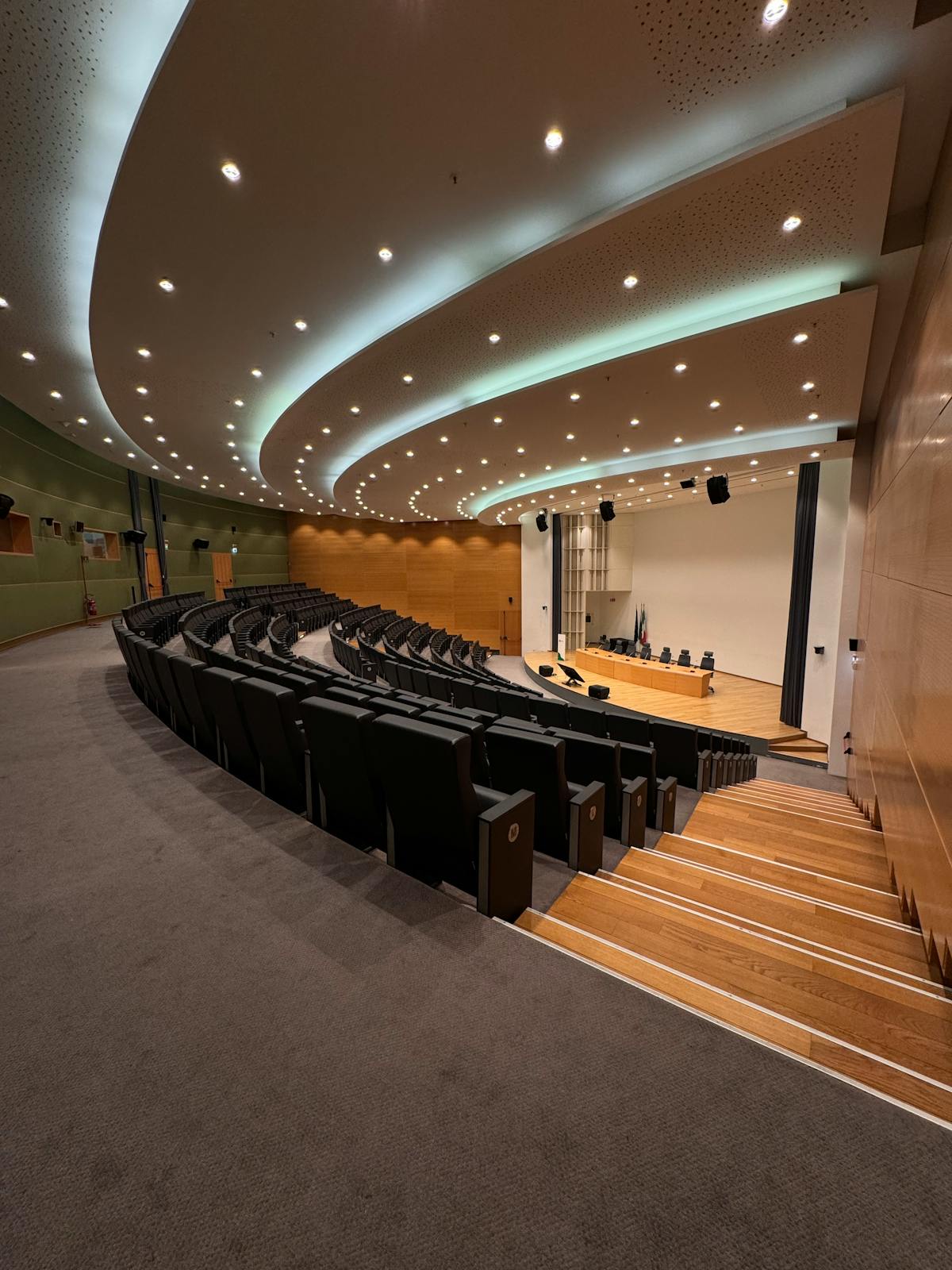 Modern tiered conference auditorium facing the stage